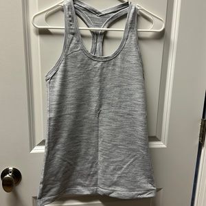 Light gray lululemon workout top. Fits like size 6.